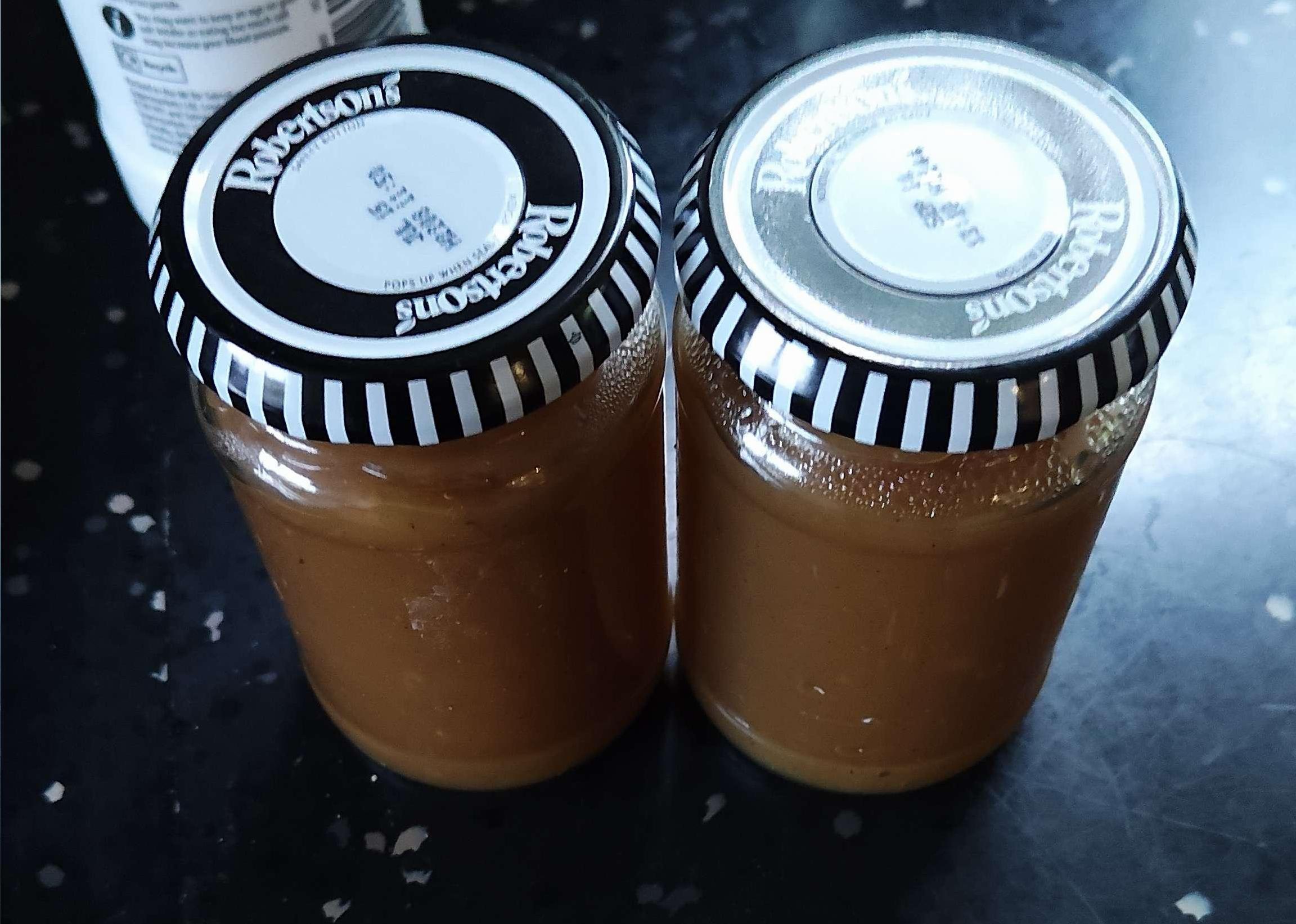 A photo of two jars of apple butter.